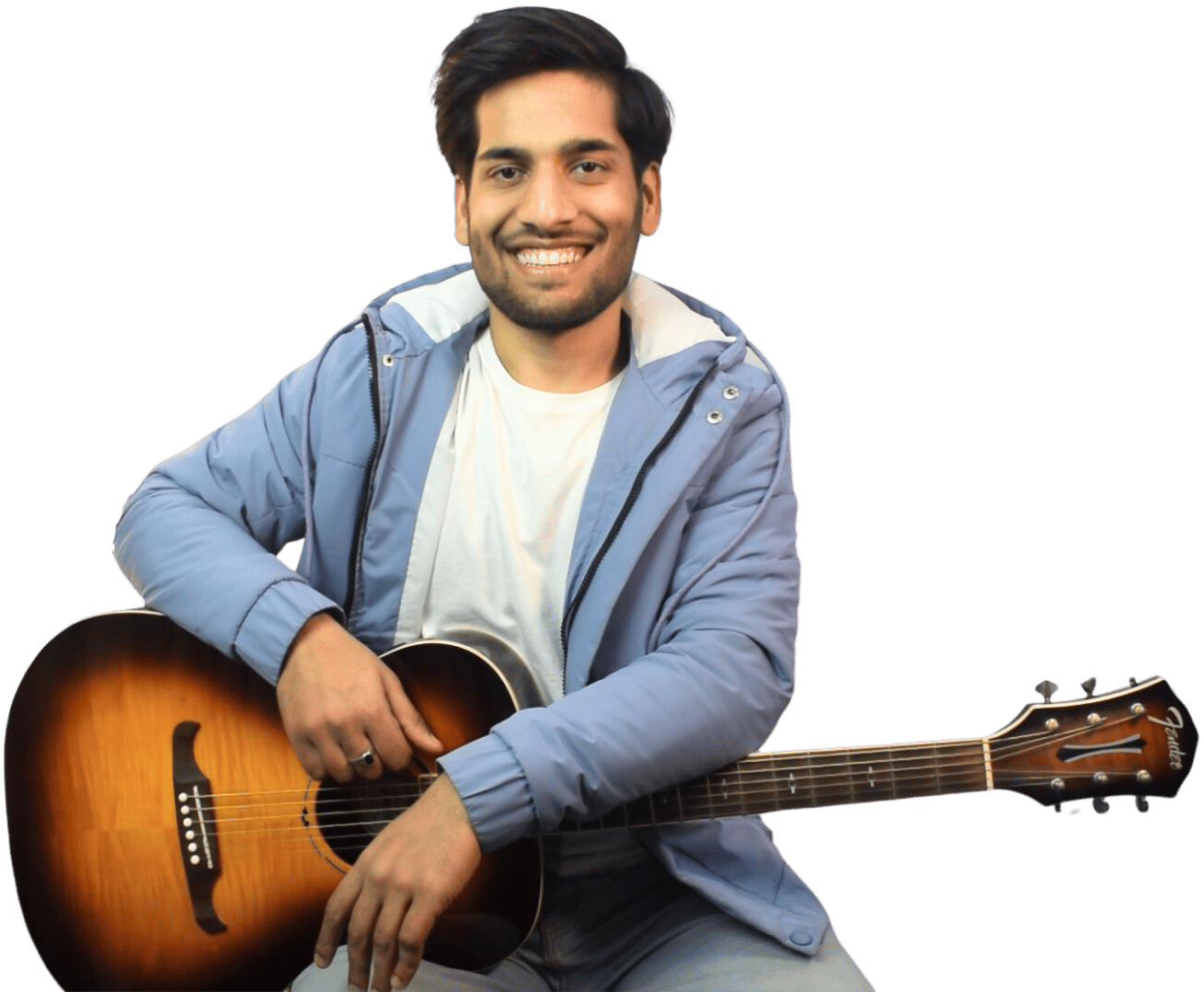 A smiling man holding a guitar and looking at a screen